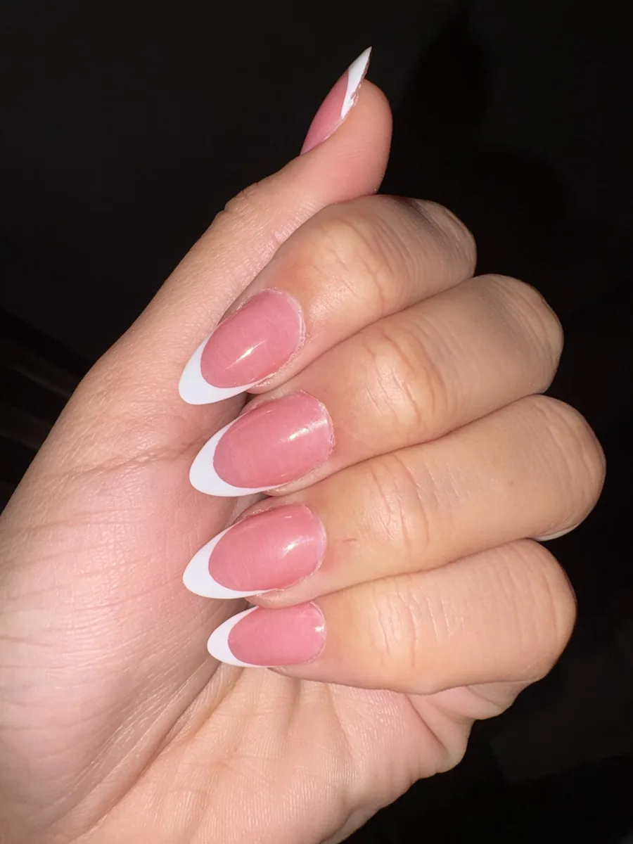Almond shaped nails with a soft pink base and crisp white French tips